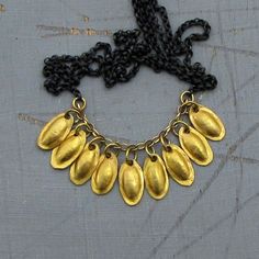 "Handmade delicate 22k solid gold and silver necklace. Nine gentle and textured oval leaves pendants made of 22 karat gold hanging on 14k gold chain and an oxidized sterling silver chain with 14k gold hoop claps. ~ Chain length - 18.5\" (47 cm). ~ Gold pendant Length (all the leaves) - 1.37\" (3.5 cm). The necklace will be packed in a gift box ready to be given as a gift, and will be shipped via express mail service that usually takes 3-10 days to arrive. ▶ View my other necklaces here: https:// Gold Teardrop Necklaces Hand Forged, Gold Teardrop Hand Forged Necklace, Oxidized Yellow Gold Pendant Necklace, Yellow Gold Oxidized Pendant Necklace, Gold And Silver Necklace, Gold Leaf Necklace, Gold Dots, Leaf Necklace, Leaf Pendant