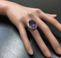 10.85 Carats Natural Amethyst and Diamond 18K Solid White Gold Ring Suggested Replacement Value: $6,000.00 Total Natural Oval Shaped Amethyst Weights: Approx. 9.90 Carats Amethyst Measures: 16.00 x 12.00mm Natural Round Diamonds Weight: .95 Carats (color G-H / Clarity SI1-SI2) Ring total weight: Approx. 6.0 grams Disclaimer: all weights, measurements and colors are approximate and may vary slightly from the listed dimensions or as seen in the image. All pictures are magnified to show the smalles Luxury Purple Gemstones With Halo Setting, Luxury Amethyst Ring With Halo Setting, Formal Amethyst Jewelry With Halo Setting, Luxury Purple Amethyst Platinum Ring, Luxury Purple Diamond Ring For Formal Occasions, Luxury Amethyst Ring With Diamond Halo Setting, Luxury Purple Amethyst Ring In Platinum, Luxury Sterling Silver Amethyst Ring For Formal Occasions, Luxury Sterling Silver Amethyst Ring For Formal Events