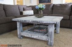 a living room with couches and a coffee table in the middle, on carpeted flooring