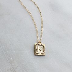 "Trendy and chic this necklace is made for everyday! Wear your favorite letter a rectangle pendant, perfect for a gift too! D E T A I L S -Gold plated rectangle initial pendant -14kt Gold filled shimmering drawn link necklace LENGTH - Please select from the drop down selection. - Choose a 16, 18 or 20 inch inch necklace length. - Standard Length is 18 inches - Pictured at 18\" in photos. C O M P L E T E ∙ T H E ∙ L O O K Styled with: Chunky Link Chain 16\" ∙ EXTRA LOVE ∙ Crafted and curated just Gold Initial Necklace With Paperclip Chain For Everyday, Minimalist Gold Initial Necklace With Paperclip Chain, Gold Minimalist Initial Necklace With Paperclip Chain, 14k Gold Filled Initials Necklace For Everyday, Gold Rectangular Pendant Initial Necklace With Adjustable Chain, 14k Gold Filled Initial Pendant Charm Necklace, Everyday Initial Necklace With Paperclip Chain, Square Pendant Initial Necklace Gift, Tarnish Resistant Square Pendant Initial Necklace For Gift