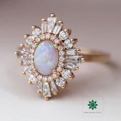 ♦ Main Stone: Ethiopian Opal ♦ Size: 1.25 CT (8x6 mm) ♦ Cut: Oval Cut ♦ Shape: Oval ♦ Color: White with Colored Flakes ♦ Ring Metal: 925 Silver/Gold ♦ Side Stones: Round & Tapered Baguette Cut ♦ Side Stones: 0.55 CTTW Approx.  ♦ Nickle Free ♦ Free Shipping to the United States ✥ O T H E R ∙ I N F O R M A T I O N ✥ ♦ Due to every item in our shop is made to order we are open for moderate customization on demand. Contact us prior to the order. ♦ Your item will be nicely packed to gift in elegant jewelry boxes. ♦ Some pictures show the listed engagement ring with various bands just to show how versatile it looks when paired with them, but they are not included with the Ring if it is not mentioned in the item description. ♦ The jewelry Certificate will be sent separately if demanded prior to t Heidi Gibson, Yellow Gold Ring, Halo Ring, Elegant Jewelry, Opal Gemstone, Solid Yellow, Opal Rings, Yellow Gold Rings, Ethiopian Opal