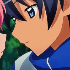 two anime characters one with pink hair and the other wearing blue looking at each other