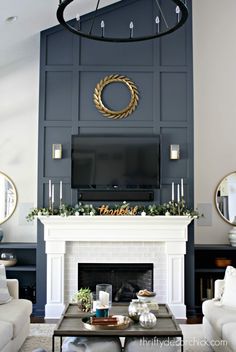 a living room filled with furniture and a flat screen tv mounted on the wall above a fireplace