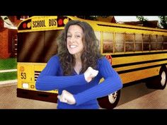 a woman standing in front of a school bus