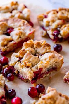 cranberry cobbler bars cut in half on a piece of parchmented paper