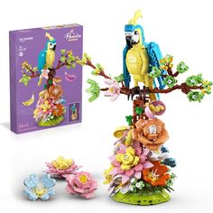 the lego bird tree is next to its box and instructions on how to make it