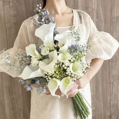 a woman holding a bouquet of flowers in her hands