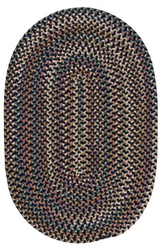 an oval rug with multicolored braiding on the bottom and black, blue, red