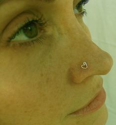 a woman with a nose piercing on her nose