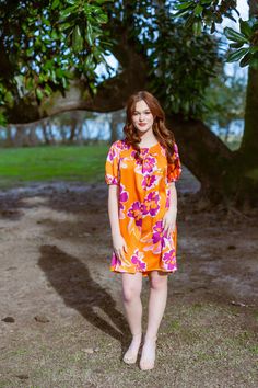 Bring on the sunshine! Our tropical flower print mini vacation dress will have you in style for all those upcoming tropical vacations! It features a bright, bold orange and pink floral pattern, short balloon cuffed sleeves, a high low hemline, and a flowy sillhoutte! The eye-catching floral print is sure to turn heads. Its the perfect way to make a statement no matter the occasion. Item Description: Floral Print Smocked Round Neckline Mini Dress Short Balloon Cuffed Sleeves No Lining Fabric Cont Vibrant Floral Print Mini Dress For Beach, Short Sleeve Tropical Print Mini Dress, Tropical Short Sleeve Floral Mini Dress, Tropical Multicolor Printed Mini Dress, Umgee Clothing, Non-stretch Floral Print Mini Dress For Beach, Mini Vacation, Pink Floral Pattern, Tropical Vacation