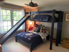 a bunk bed in a bedroom next to a window