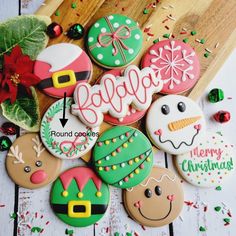 decorated christmas cookies sitting on top of a wooden table