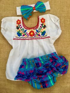 So cute ! Mexican bloomer with embroidered blouse and headband.  Size: 12-18 months  Bloomer fabric : cambaya rebozo  Blouse : poplin  Hand wash only Summer Cotton Sets With Matching Headband, Cotton Matching Set With Headband For Summer, Cotton Sets With Matching Headband For Summer, White Cotton Sets With Matching Headband, Cute Embroidered Fitted Sets, Cute Embroidered Cotton Sets, Summer Multicolor Embroidered Sets, Summer Embroidered Multicolor Sets, Multicolor Cotton Ruffled Sets