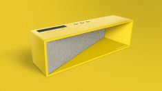 a yellow and grey speaker on a yellow background