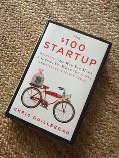 the $ 100 start up book is laying on the floor