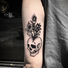 a skull with flowers on it's arm