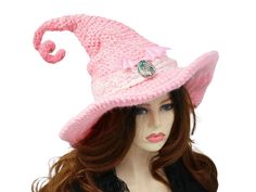 Ready for the Renfaire, a festival, cosplay, a pagan celebration, your table centerpiece, this pink bat wing witch hat is ready for the occasion. Firmly structured but soft to wear, you can shape this hat just about any way you like because both the tip and the brim are wired. I crocheted this in a an ombre of pink shades, dark at the top to light at the edge of the brim.  A real abalone cabochon rests at the front with a cream colored stretchy lace hat band. Pink luster bat wings rest above the cabochon, for that extra pretty touch of witchy. Twist up that tip any way you like and let the hat do the talking. When you're not wearing it, you can toss it on your table for a great conversational centerpiece, or hang it on a hook by the door! Folds flat for travel. -This soft witchy hat has so Handmade Gothic Costume Hats And Headpieces For Parties, Handmade Gothic Costume Hats And Headpieces, Themed High Crown Costume Hats For Cosplay, High Crown Costume Hats For Halloween Cosplay, High Crown Costume Hats For Cosplay Halloween, Brimmed Costume Hats And Headpieces, Whimsical High Crown Costume Hat, Halloween Cosplay Costume Hat With High Crown, Pink Wide Brim Costume Hat For Festival