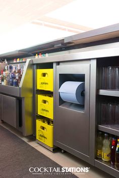 an empty counter in a restaurant with yellow bins