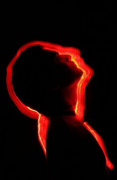 a red light is shining on the back of a person's head and neck