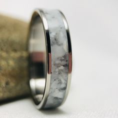 Titanium memorial ring with cremation ashes from a loved one. This is certainly one of the most meaningful rings I make. Any color combo is possible and the addition of other materials is also and option. This particular ring is set in a pearl white resin. Ashes can be added to almost anyone of my rings which has an inlay. I'm truly honored every time I'm approached to make a memorial ring. - For sizing assistance and transportation of cremation ashes, please click the link below. By purchasing White Gold Titanium Rings For Gift, White Gold Titanium Promise Ring, Sterling Silver Keepsake Rings, Silver Keepsake Ring, Untreated White Jewelry For Anniversary, Untreated White Wedding Rings, Hua Lian, Cremation Glass Art, Resin Ashes