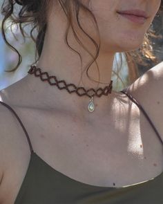 a close up of a woman wearing a necklace