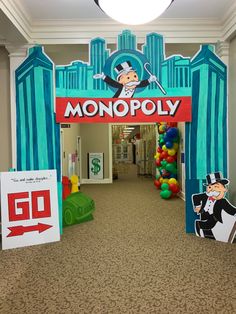 the entrance to monopoly is decorated with balloons and paper cutouts for kids's birthdays