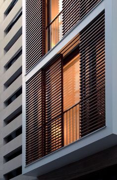 an apartment building with wooden slats on the side