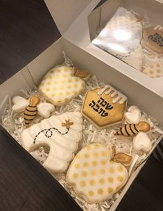 a box filled with decorated cookies sitting on top of a table