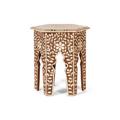 an intricately carved wooden table on white background