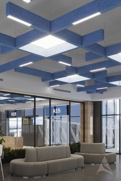 an office lobby with blue and white ceiling tiles