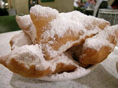 powdered sugar covered pastries are on a plate