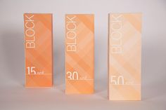 three orange boxes with the number fifty and one block printed on them are lined up against a white background