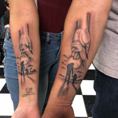 two people holding hands with tattoos on their arms