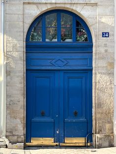 a blue door with two windows on the outside