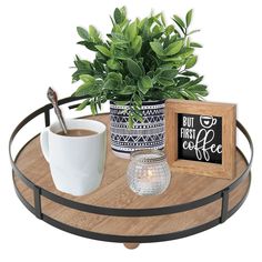 a wooden tray holding a cup of coffee and a potted plant