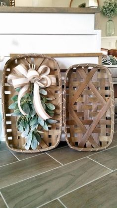 two wicker baskets sitting on top of a tile floor