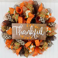 a wreath that says, thank you and decorated with pumpkins