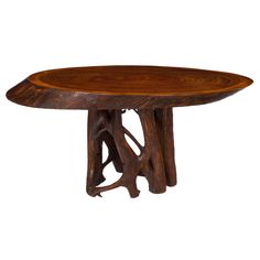 a wooden table that has been carved into the shape of a tree trunk with two branches on it