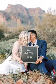 a newly married couple kissing in front of a sign that says we bloped 3 31 20