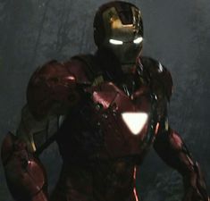 iron man standing in the woods with his hands on his hips