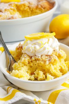 a close up of a plate of food with lemons and whipped cream on it