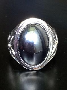 This is a very rare and perfect and unique powerful ring made of black stone and silver, the power of the ring is to bring good luck and charm, wealth to the wearer. The ring showcases an elegant design with unique amulet style ring. It is great to get this ring for your loved one or treat yourself for a classic timeless style.  Ring US Size: 10,  Stone Type: Black Leklai Metal Type: Stainless, silver Weight: 16.64 Gram (Approx.) The Leklai has its own power but if you want to worship or say pra Spiritual Black Jewelry With Large Stone, Black Metal Rings With Polished Finish, Mystical Black Ring As Gift, Black Metal Crystal Ring, Black Metal Crystal Round Ring, Black Mystical Ring Jewelry, Mystical Black Ring Jewelry, Black Mystical Style Jewelry Ring, Black Spiritual Collectible Jewelry