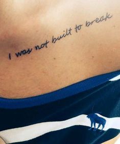 a woman with a tattoo on her stomach saying i was not built to break