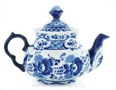 a blue and white tea pot with flowers on it