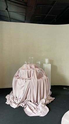 a group of wine glasses sitting on top of a pile of cloth