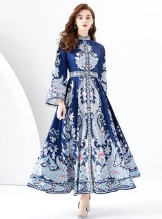 Ornate Majesty: Step into a world of timeless beauty with this ornate majesty of a dress, a masterpiece where classic elegance meets modern craftsmanship. The luxurious deep blue hue is the canvas for an exquisite white and light blue ornamental pattern, reminiscent of royal tapestries from a bygone era. This full-length dress features a fitted bodice that flows into a voluminous skirt, creating a silhouette that celebrates the female form. The high neck and long bell sleeves add a touch of sophistication and demure charm, perfect for those occasions that call for grandeur. With every stitch and fold, this dress is designed to make you feel like nobility, captivating the room with your presence. Fabric name: chiffonPattern: printingSkirt length: long skirtSkirt type: flounce skirtSleeve ty Ornamental Pattern, Blue Patterns, Voluminous Skirt, Sleeveless Dresses Casual, Flounce Skirt, Push Up Swimsuit, Full Length Dress, Bygone Era, Beach Swimsuit