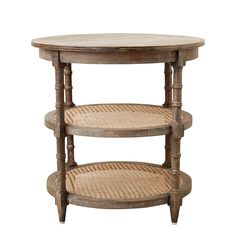 three tiered table with wicker baskets on the top and bottom shelf, against a white wall