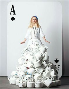 a woman standing on top of a pile of cups