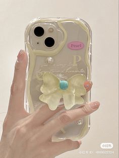 a woman's hand holding an iphone case with two flowers on the front and back