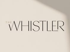 the whiszler logo on a white wall